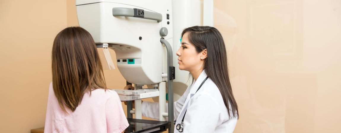 woman standing at mammography machine